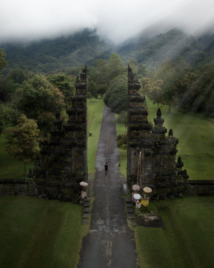 A stunning aerial view of the iconic Handara Gate amidst lush greenery in Bali, Indonesia.